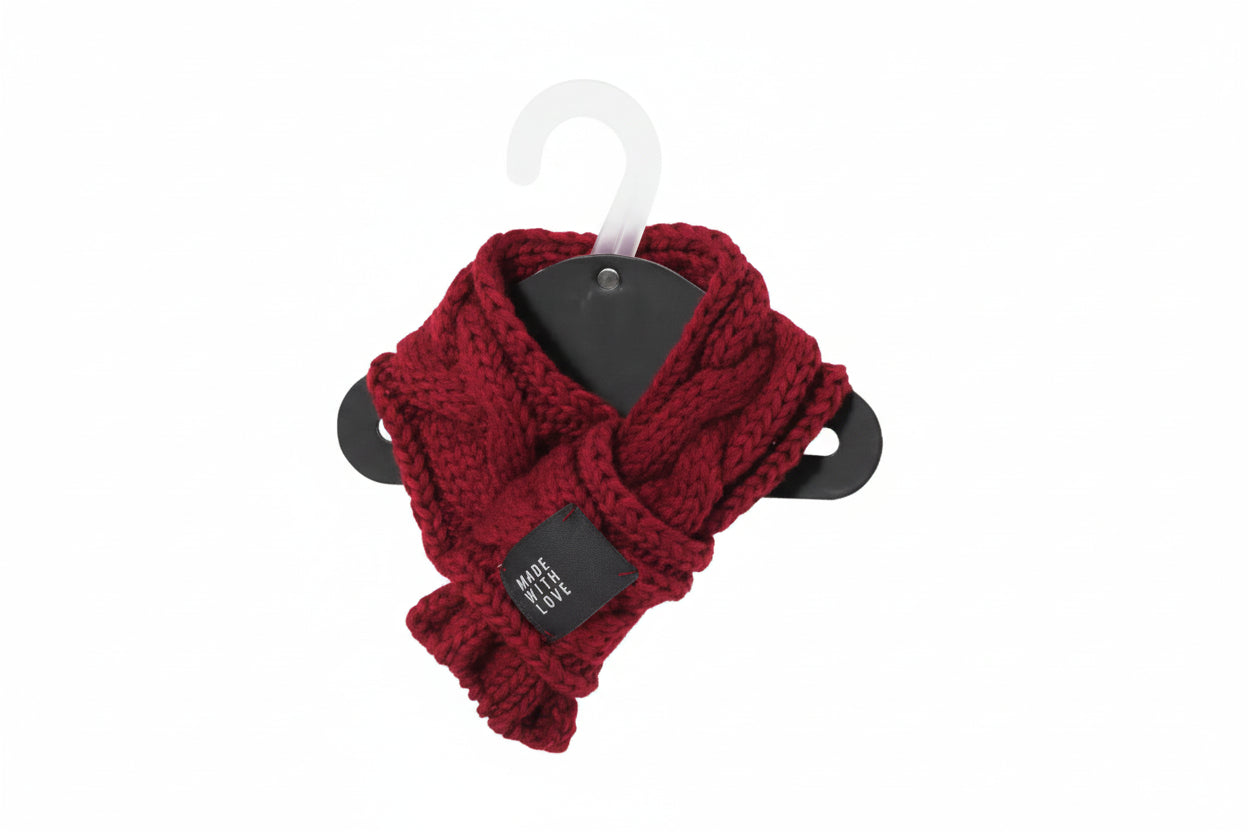 Red knitted scarf on a hanger with a tag against a white background